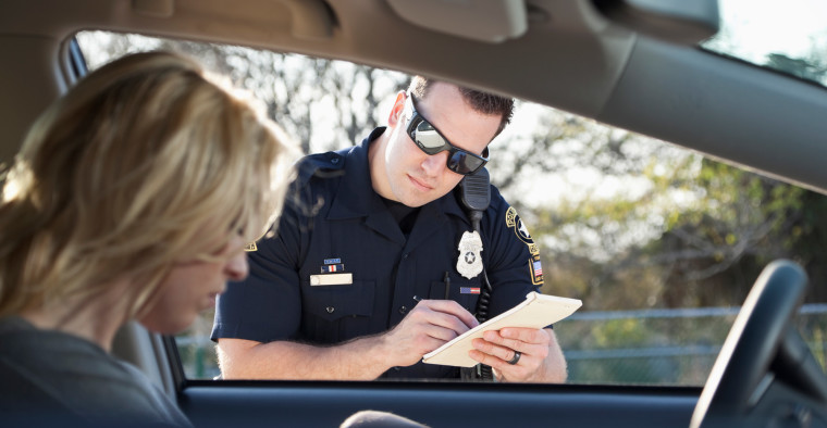 police officer writing ticket for moving violation