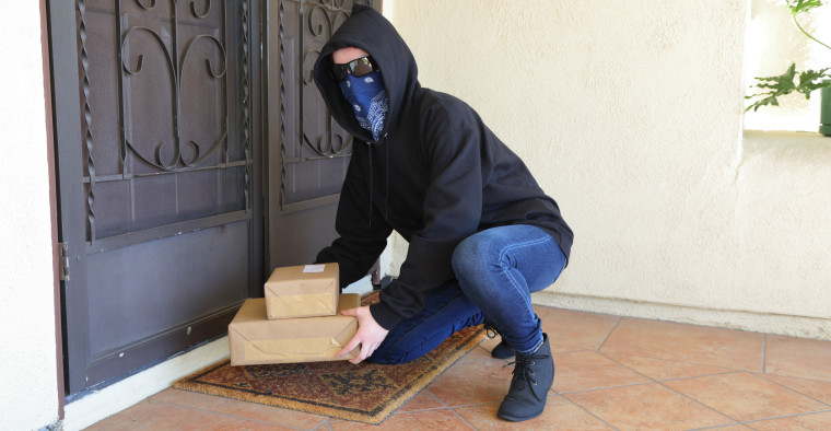A porch pirate steals packages.