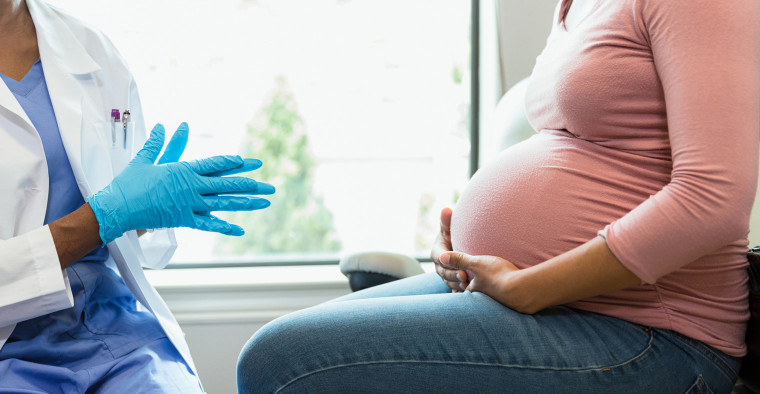 A woman receives prenatal care.