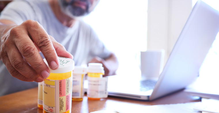 A man looks at his prescription medicine.