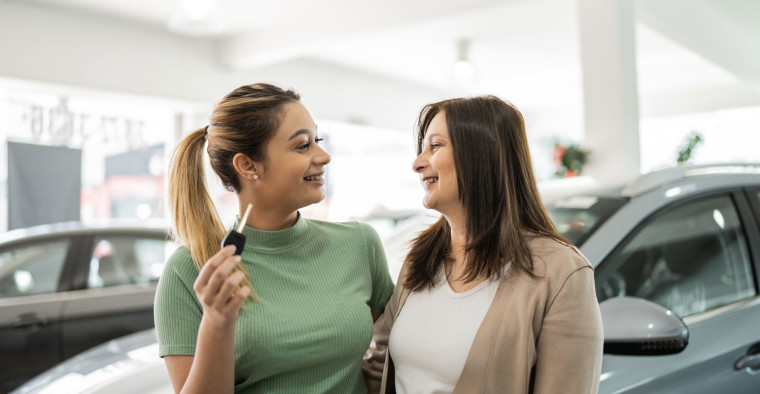 A mother and daughter purchase a used car.