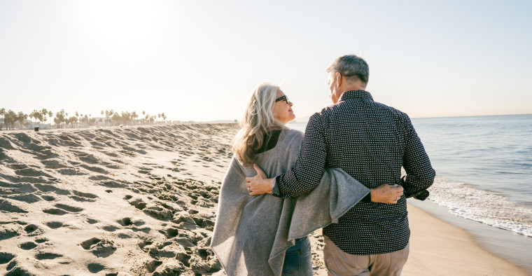 seniors with Medicare walking on beach