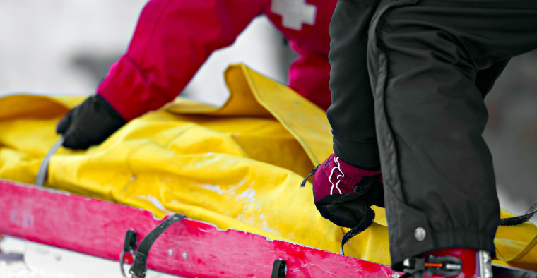Mountain medics tending to a ski accident.