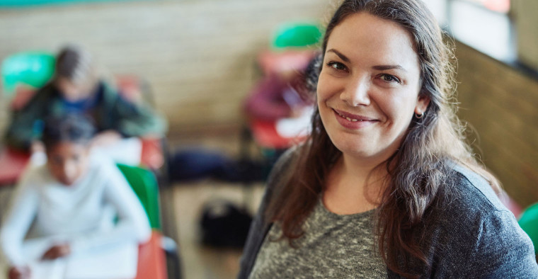 Teacher smiling in a classroom