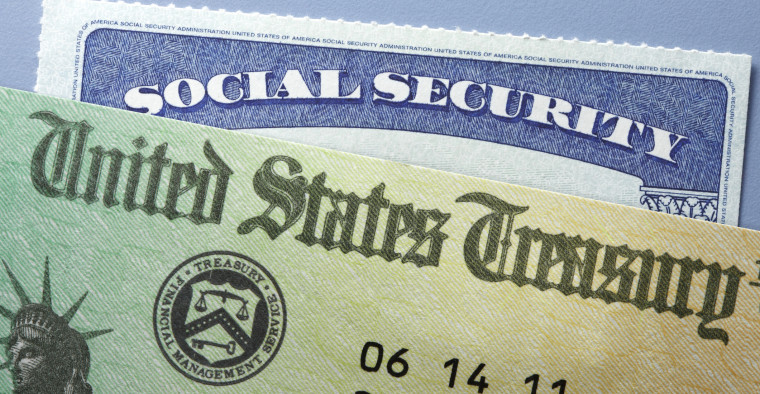 A United States Treasury check on top of a Social Security card
