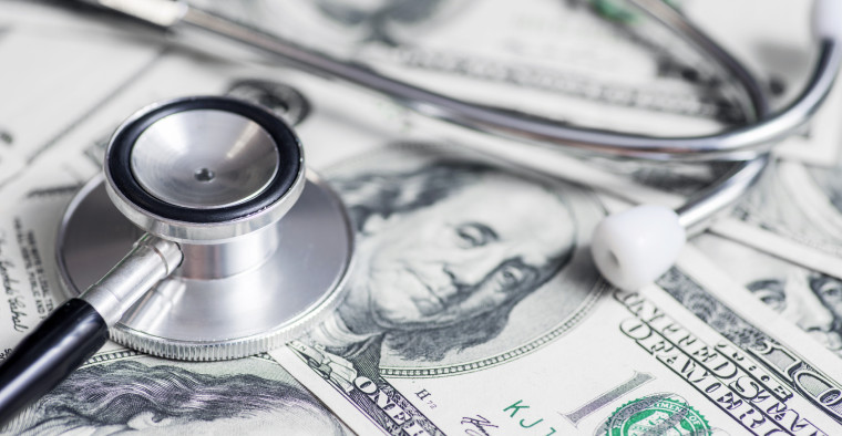 Stethoscope on hundred dollar bills