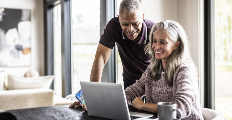 Couple on Medicare researching at a computer