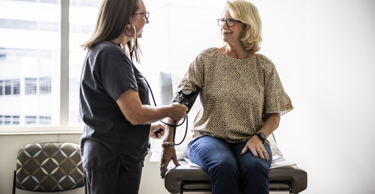 A nurse taking a patient's blood pressure