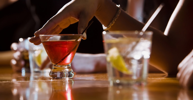 People drink in a nightclub.