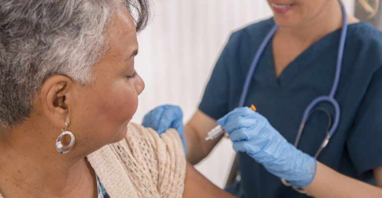A nurse administers a flu vaccination.