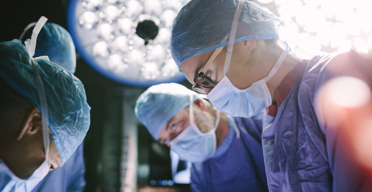 Surgeons doing a tubal ligation