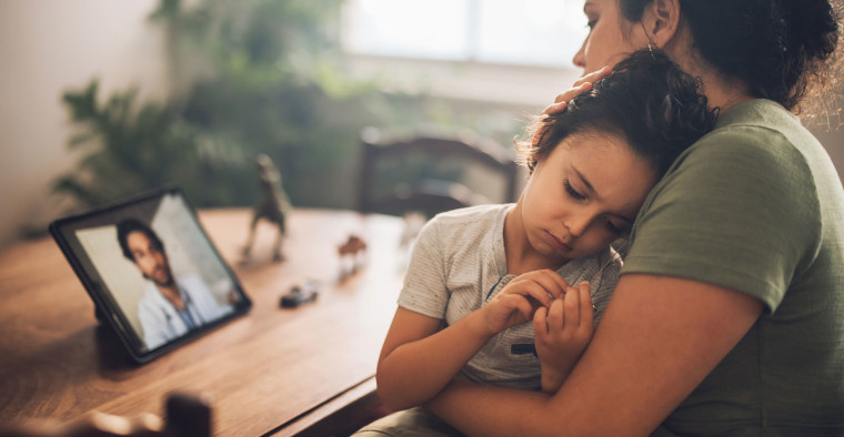 A mother utilizes a telehealth service.