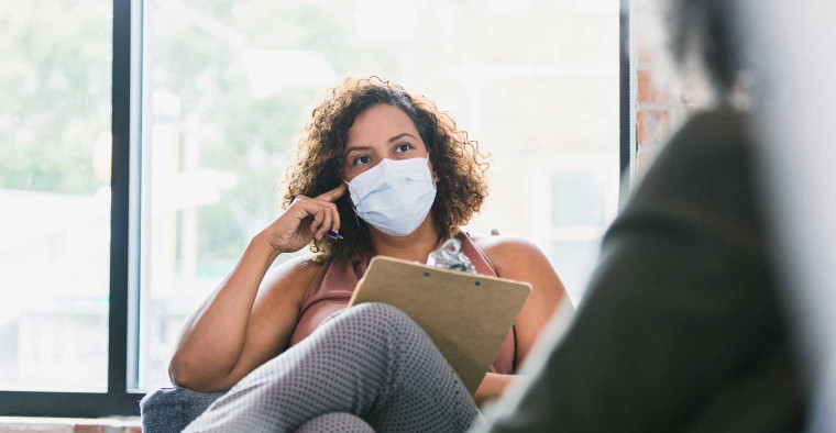 Therapist wearing a mask.