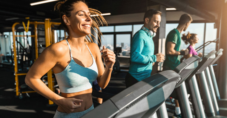 Gym-goers running on treadmill.