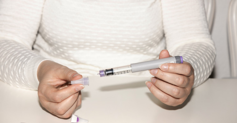 Woman holding injection pen