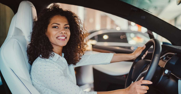 A person test driving a luxury car.
