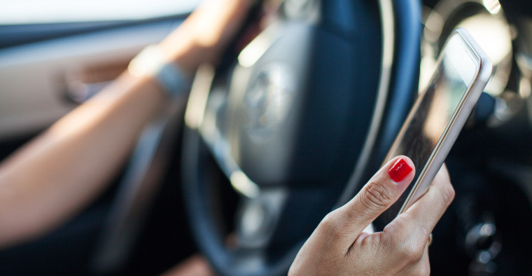 Women using phone in car.