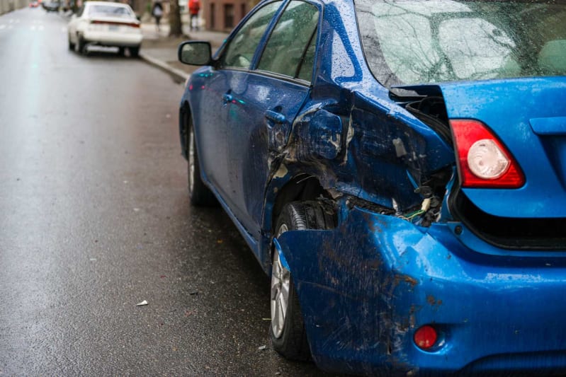 Broken car after a traffic accident in the parking lot of a repair station.  Car body