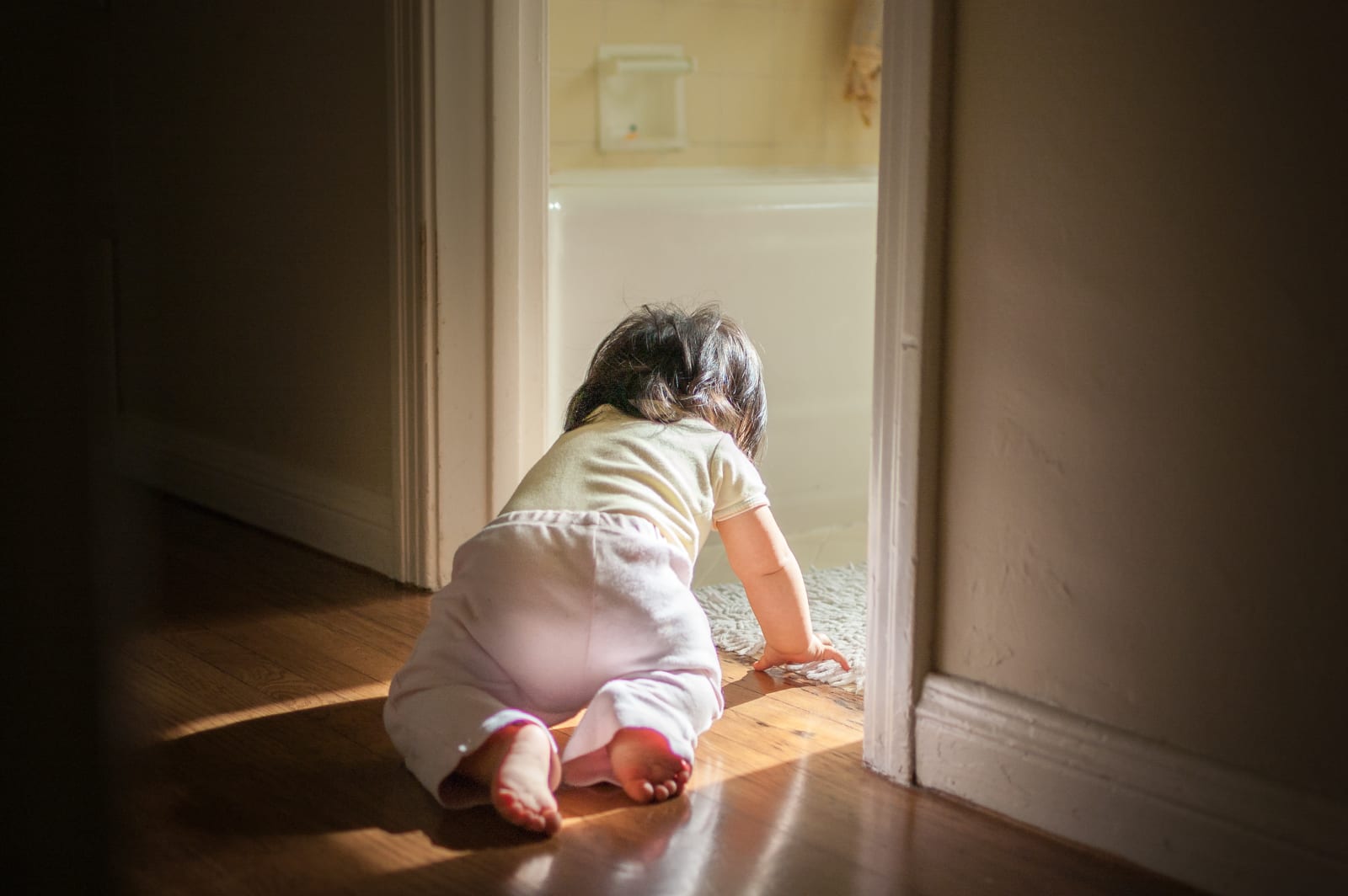 Baby crawling into bathroom