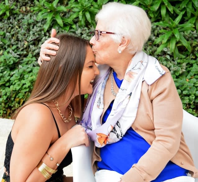 elderly lady and granddaughter embracing each other