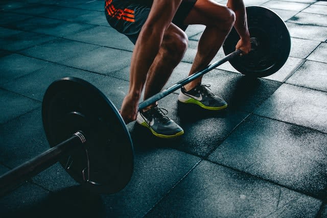 man lifting weights at the gym