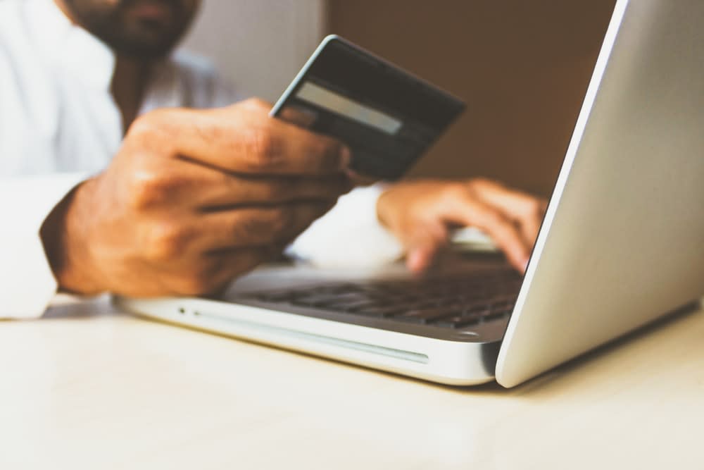 image of man paying with credit card