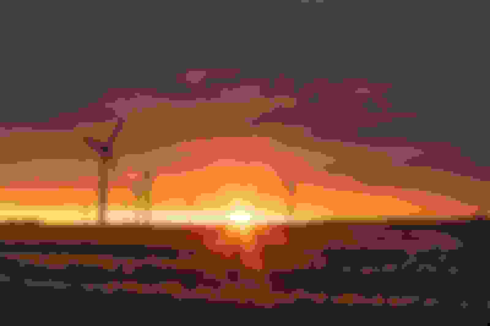 Windmill on plains with sunset