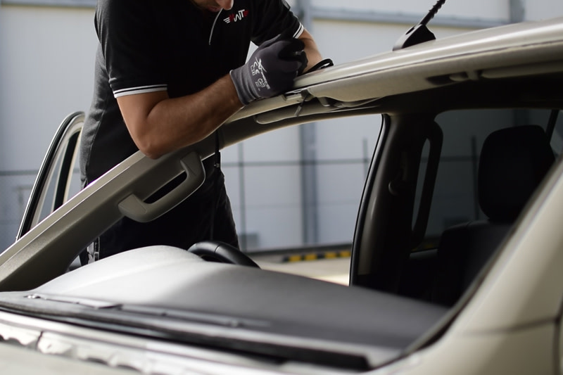 Technician removing existing glass rubber seals