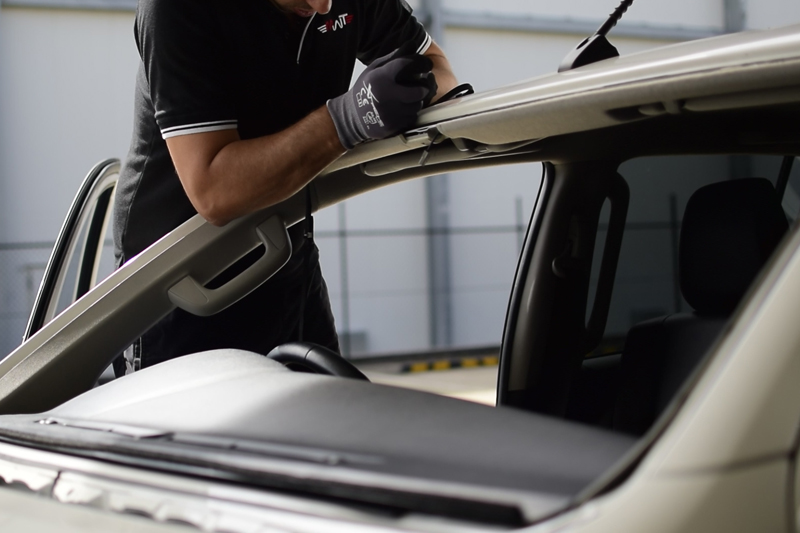 Technician removing existing glass rubber seals