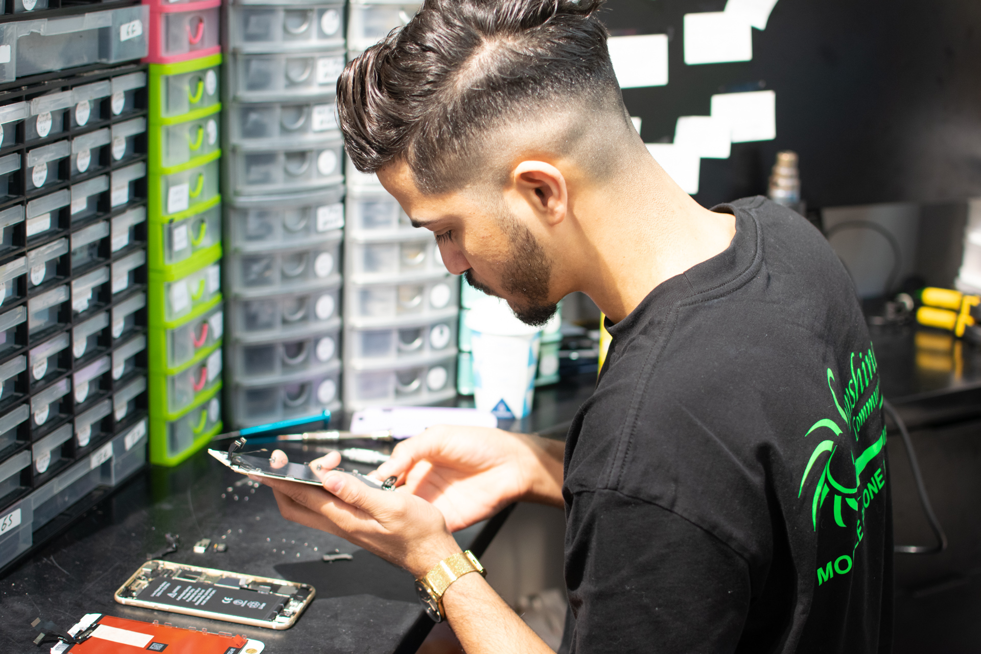Mobile phone technician repairing a phone