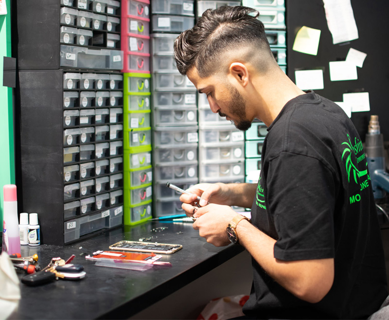 Mobile phone repair technician working