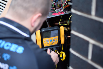 Technician servicing air conditioner unit