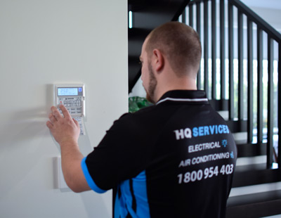 Technician inspecting air conditioner panel after service