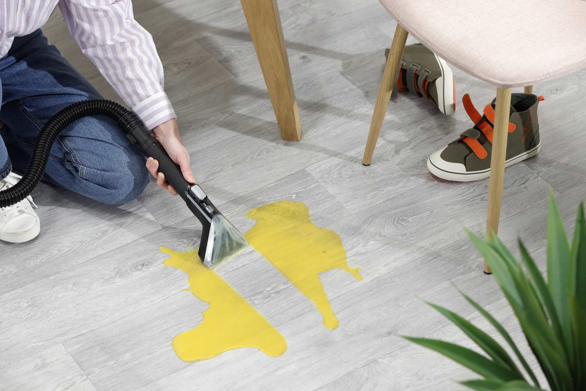 VAX Platinum Power Max Pet-Design cleaning up spills on a hard floor with the the hard floor squeegee tool