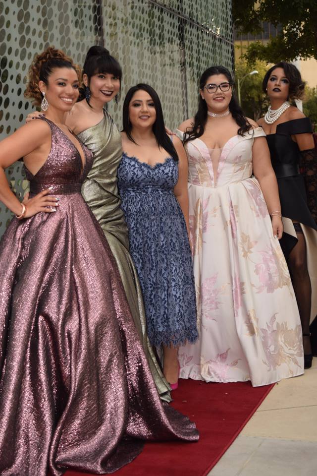 Five guests in evening gowns on the red carpet at the San Antonio Fashion Awards