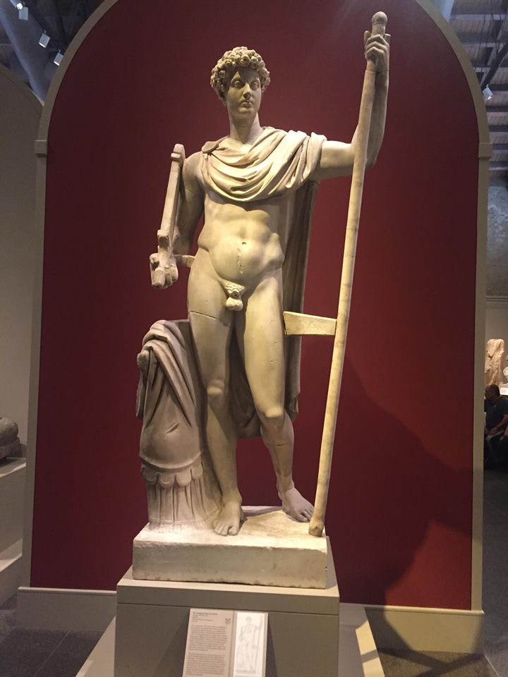 A classical Greek marble statue of a standing man at the San Antonio Museum of Art