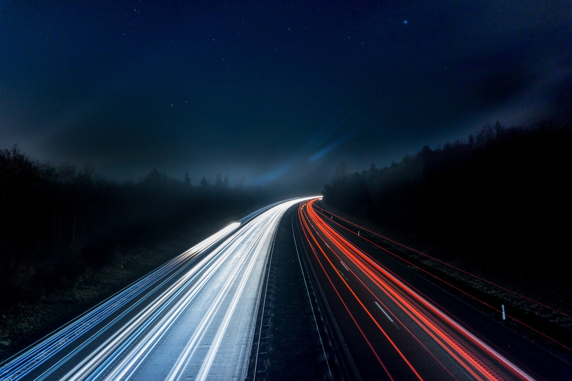 Light trails from traffic on a highway at night