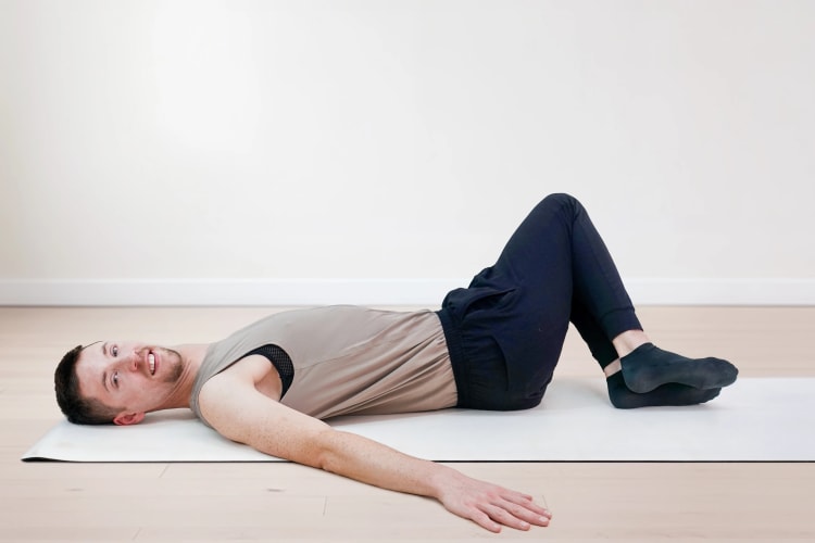 Eine Person macht die Pilates Entspannungs Übung Buch.
