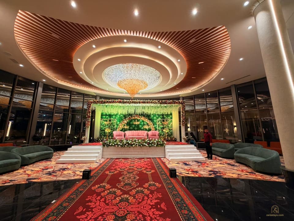 Event hall with circular ceiling feature and floral stage