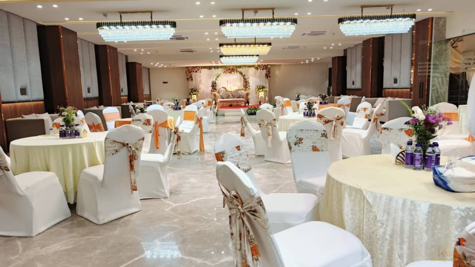 Banquet hall with round tables and covered chairs