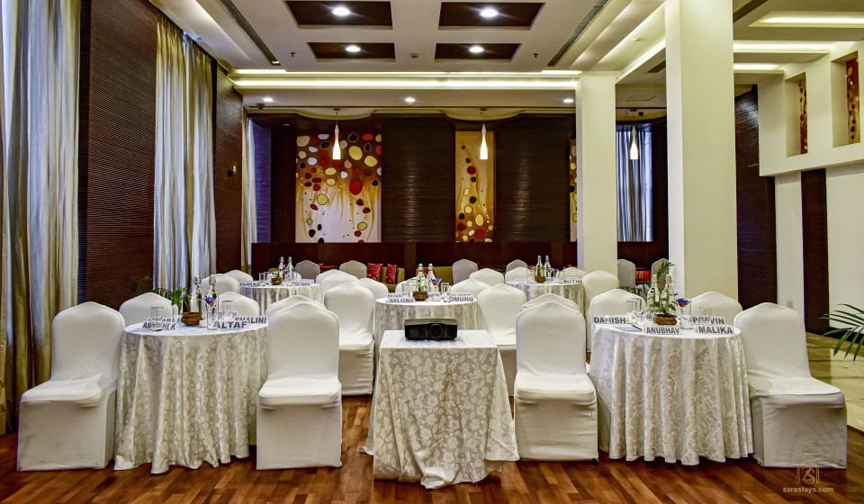 Banquet hall with round tables and covered chairs