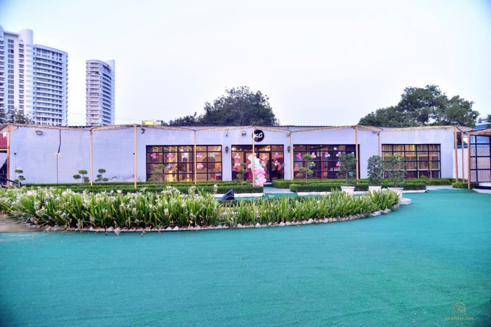 Glass-fronted event building and lawn in daylight