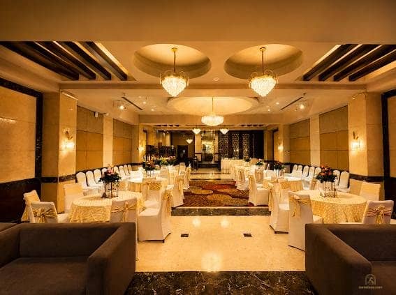 Banquet room with cream chairs and round tables