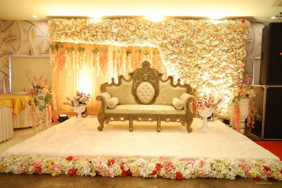Floral celebration stage and sofa