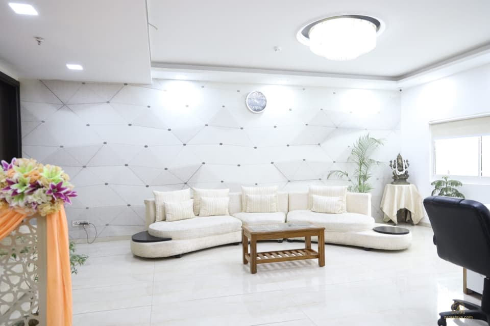 White seating area beside a geometric wall