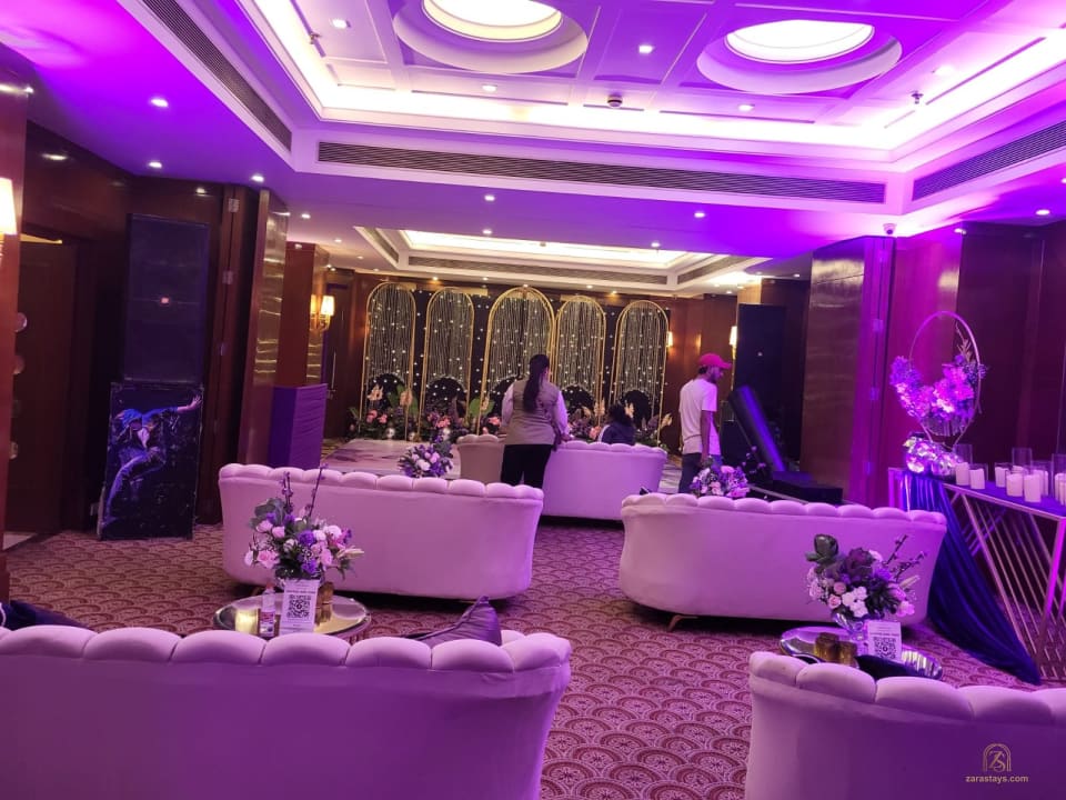 Indoor celebration with lounge seating and purple lighting
