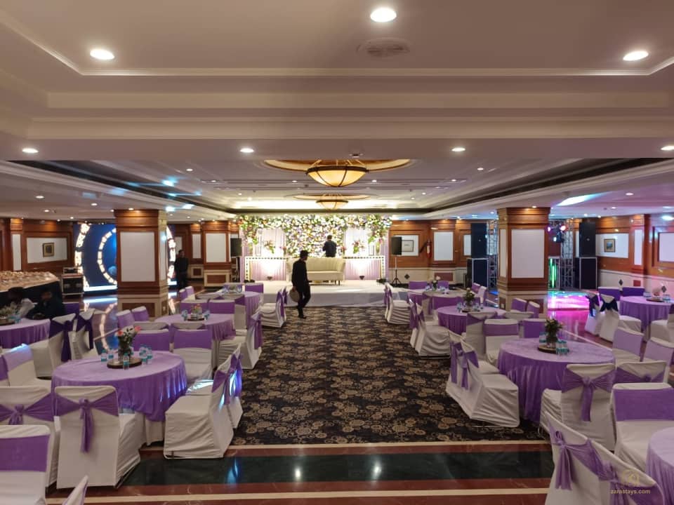 Banquet hall with round tables and a stage
