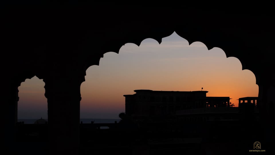 Tijara Fort-Palace silhouetted through an arch at sunset