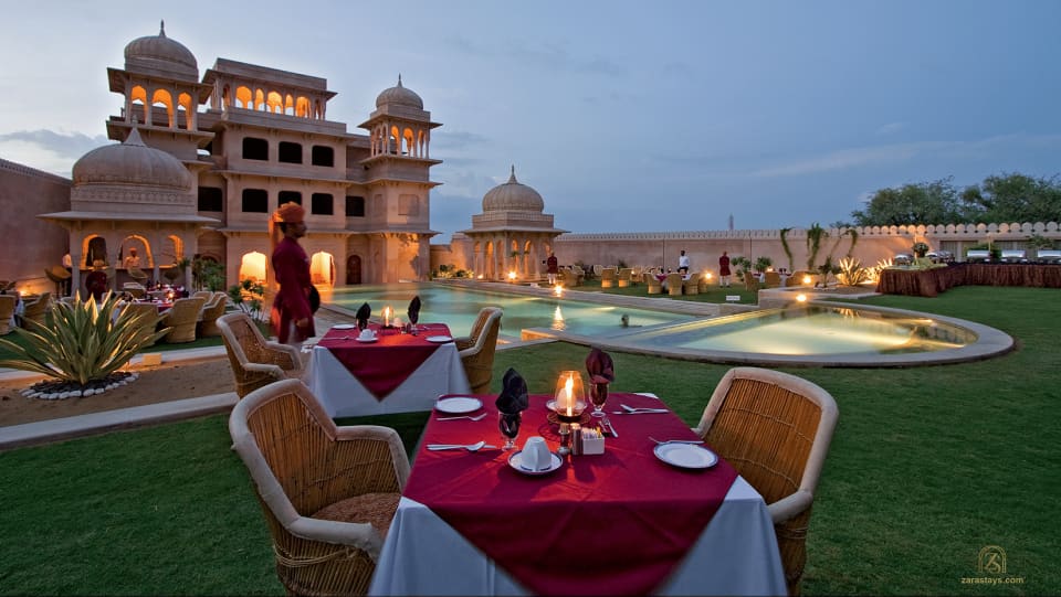 Poolside dining at Castle Mandawa at dusk