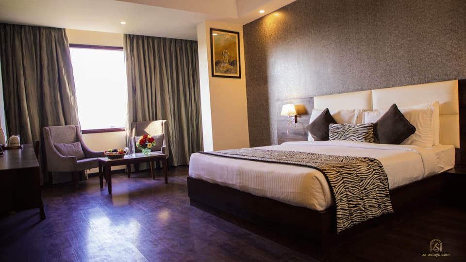 A furnished guest room at The Baagh Ananta Elite